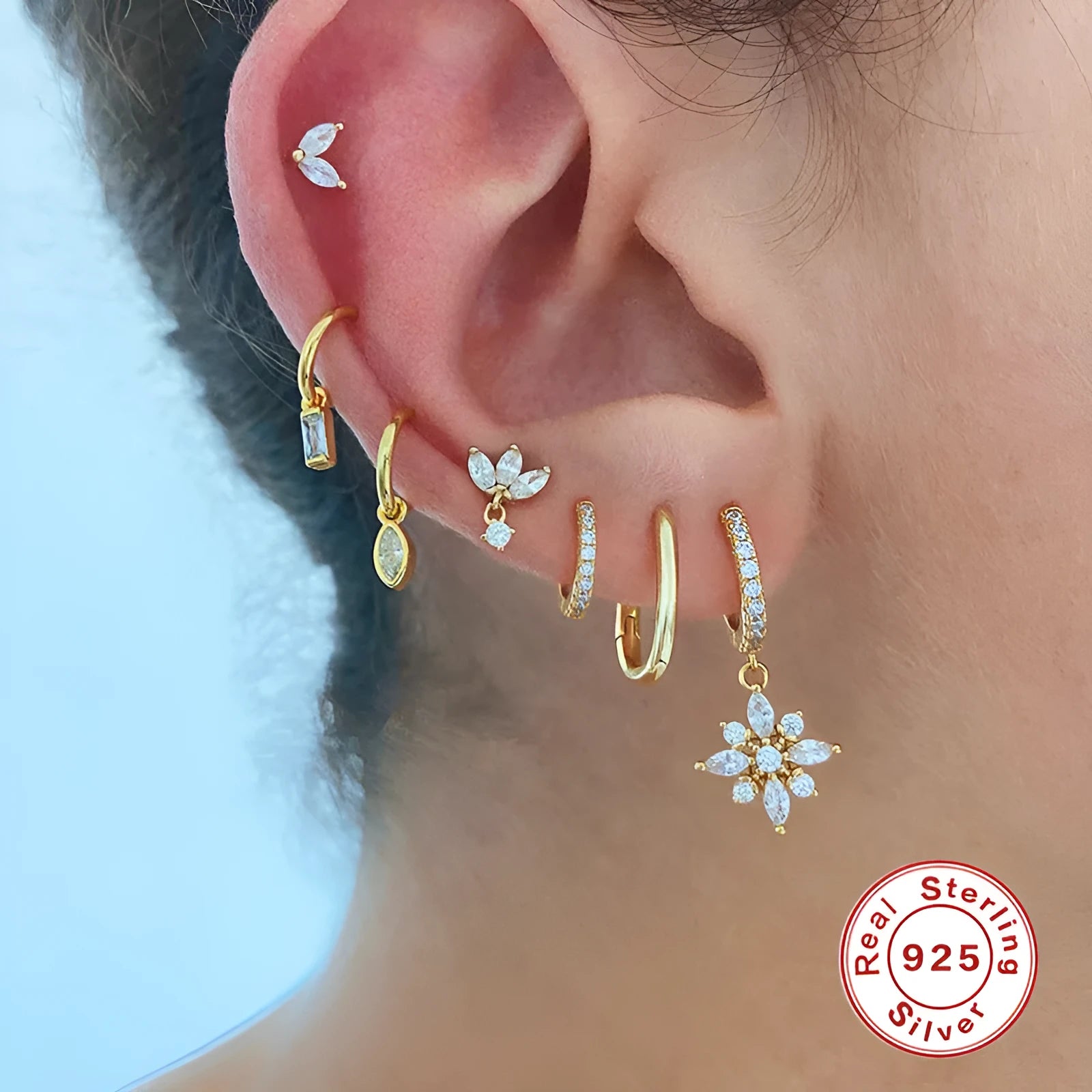 Sterling silver snowflake pendant earrings showing geometric design with gold-colour finish options