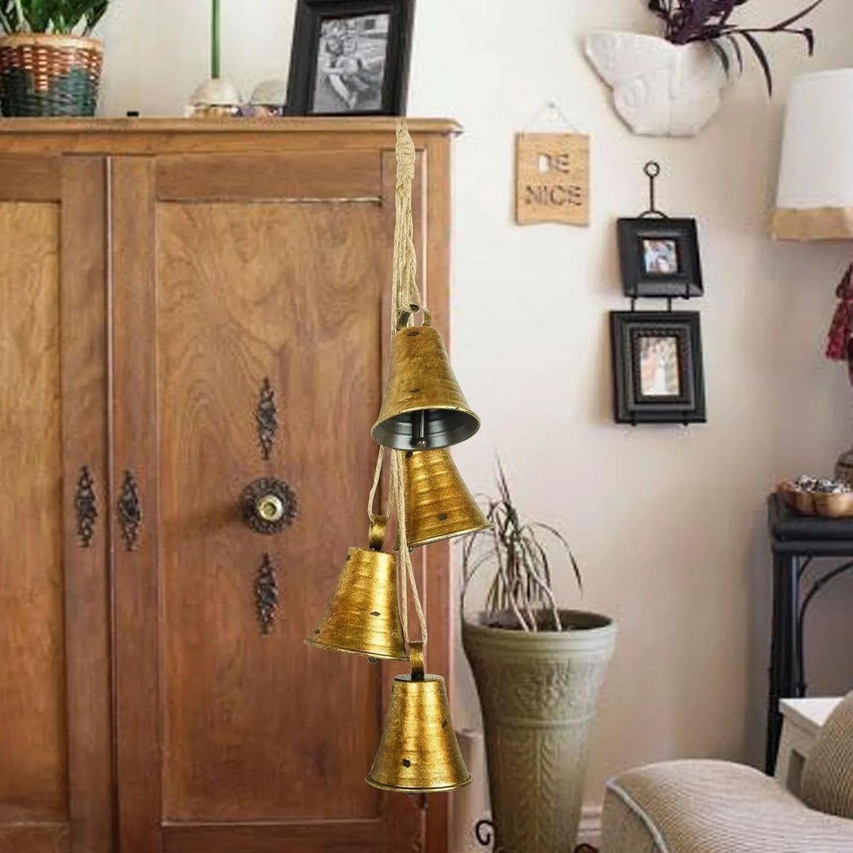 Four retro country handmade metal bells in two colour styles on a rustic wooden background