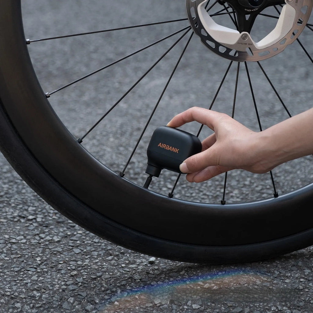 Black AS100 mini electric bicycle pump with USB cable and waterproof storage bag