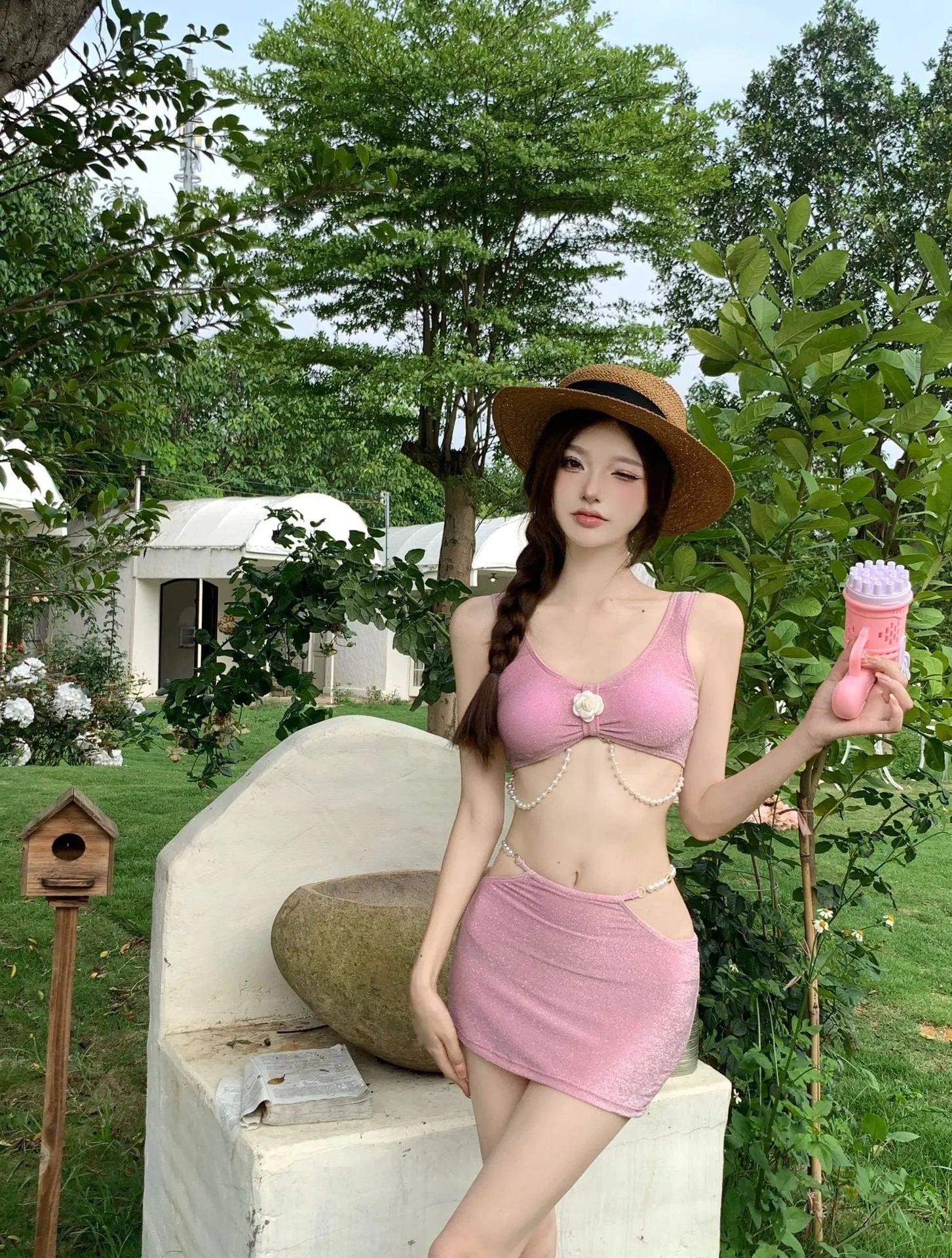 Women's pink and black three-piece polyester bikini set for swimming.