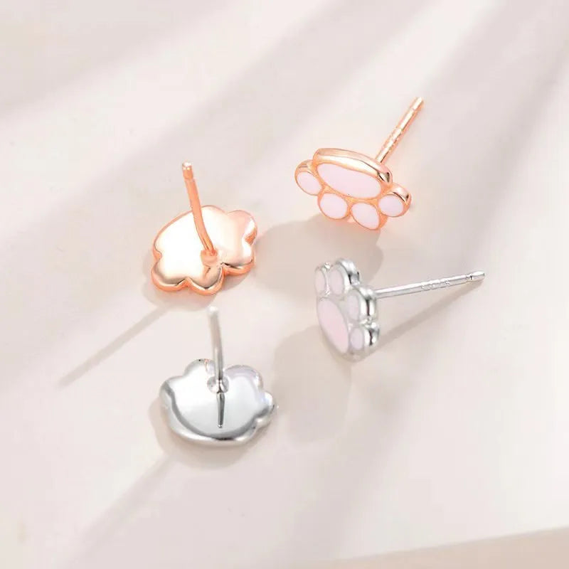 Handmade 925 silver cat paw ear studs in white gold colour finish on a white surface