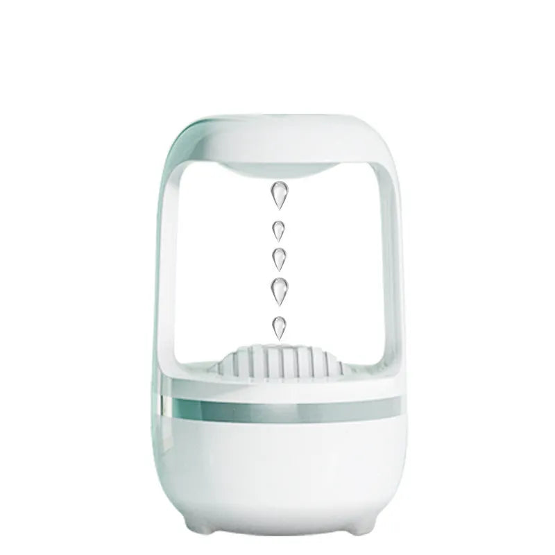 Anti-gravity humidifier with water droplet effect on desk next to USB cable