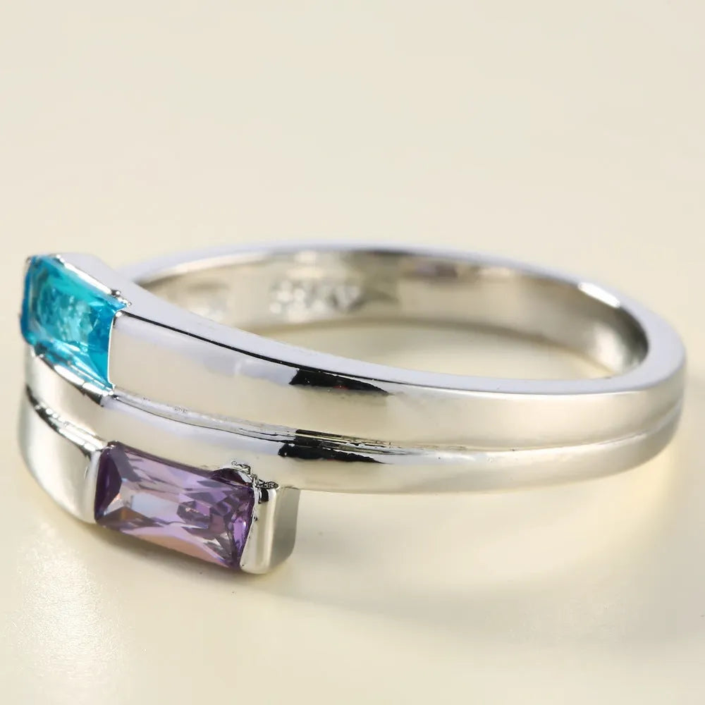 Silver electroplated copper ring with zircon stones, unisex European and American style fashion accessory.