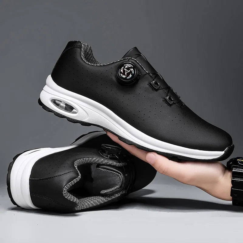 Black and white low top casual tennis shoes with mesh upper, cross shoulder straps, and composite sole.