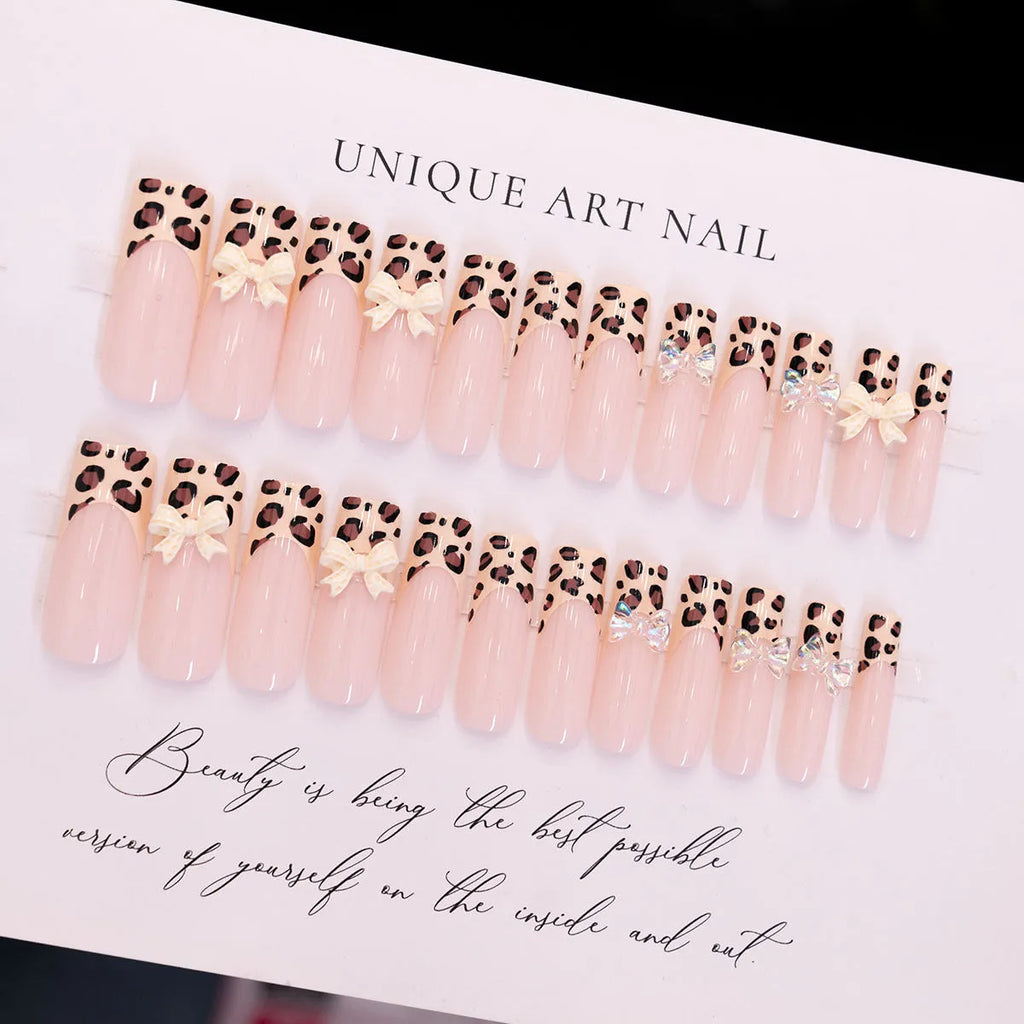 Leopard print butterfly shaped nail art decals on a plastic sheet.