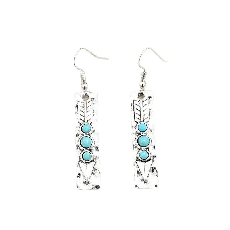 Geometric silver earrings with turquoise inlay pattern and retro styling on long strip design