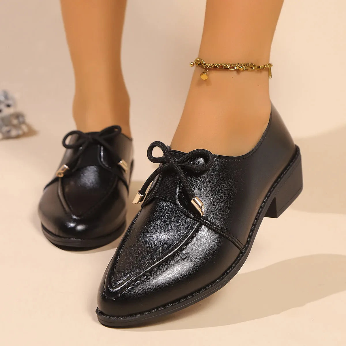 Women's British-style leather flats with bow decoration on pointed toe, showing three bow style options