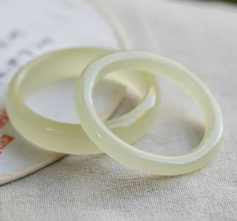 Adjustable winding bracelet made of round ice-like silk jade beads on a silk cord.