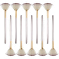 Ten champagne-coloured fan makeup brushes with soft fibre bristles and protective covers laid out.