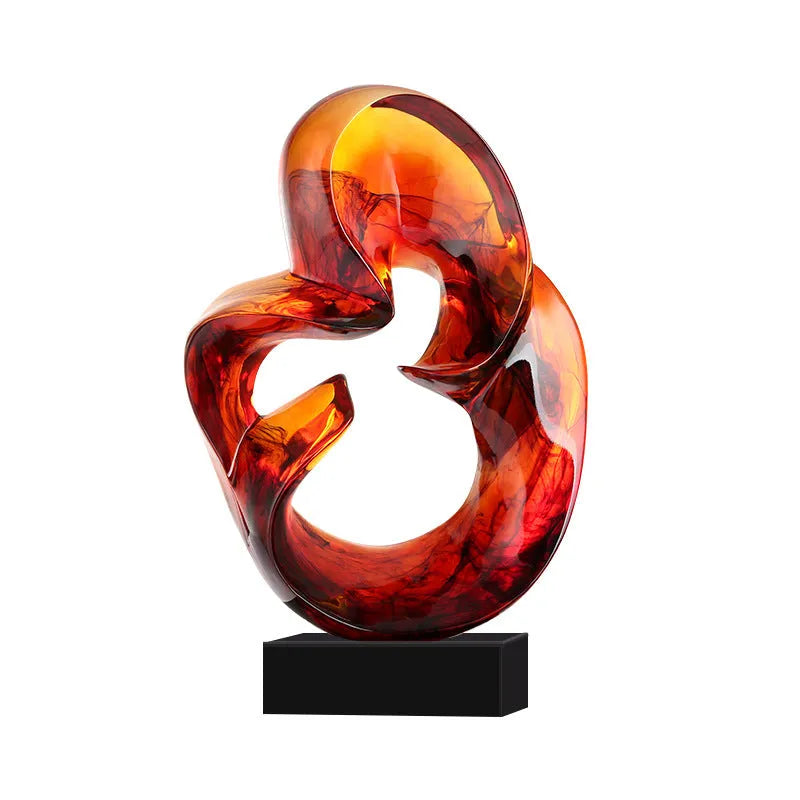 A transparent resin sculpture ornament in a modern style, shown in blue and orange red colour options.