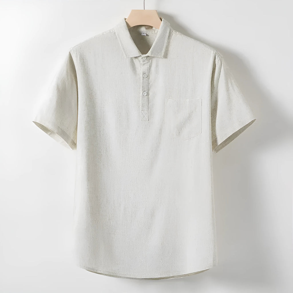 Man wearing a solid colour linen T-shirt with loose lapels and short sleeves.