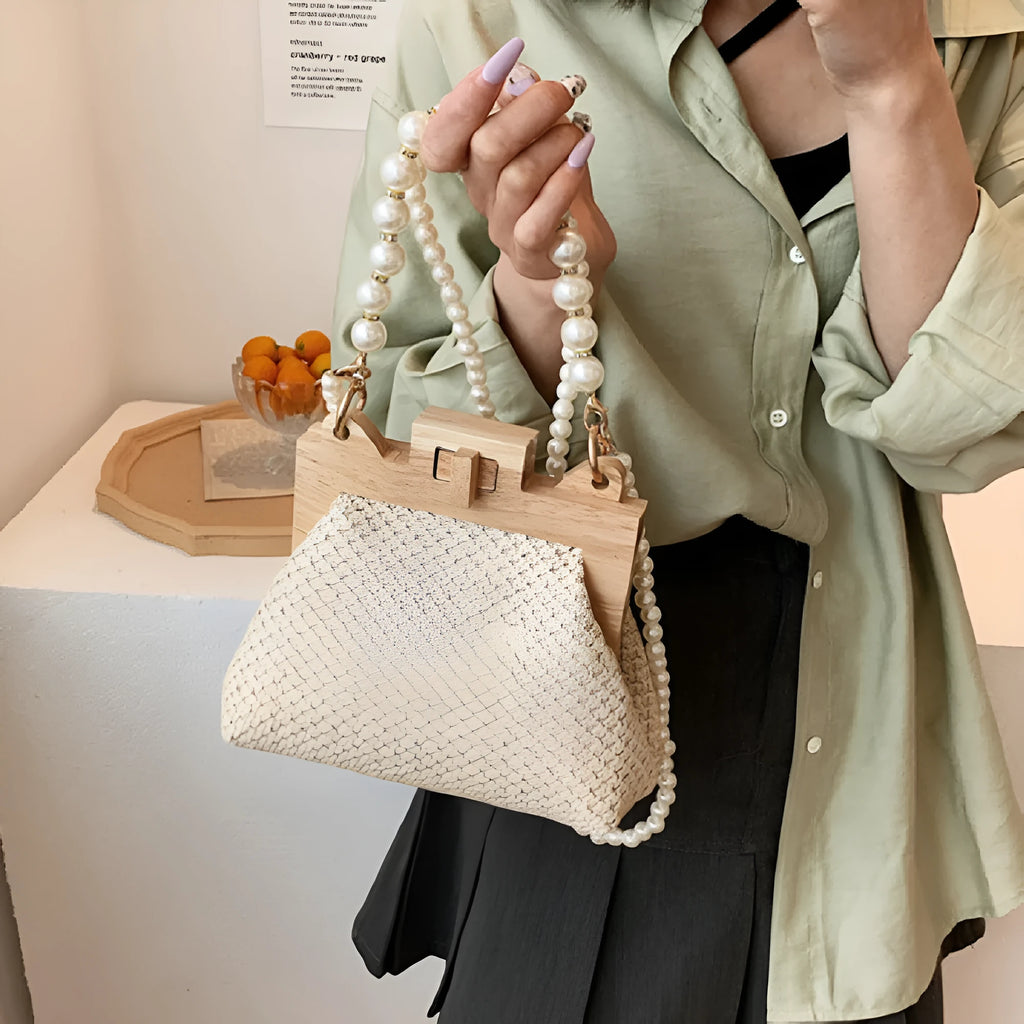 Women's straw woven shoulder bag with pearl chain strap and multiple internal compartments in horizontal square shape
