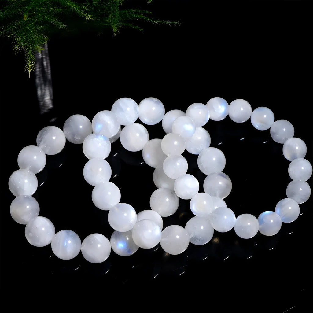Natural blue moonlight round moonstone bead bracelet on a white background showing polished gemstone beads.