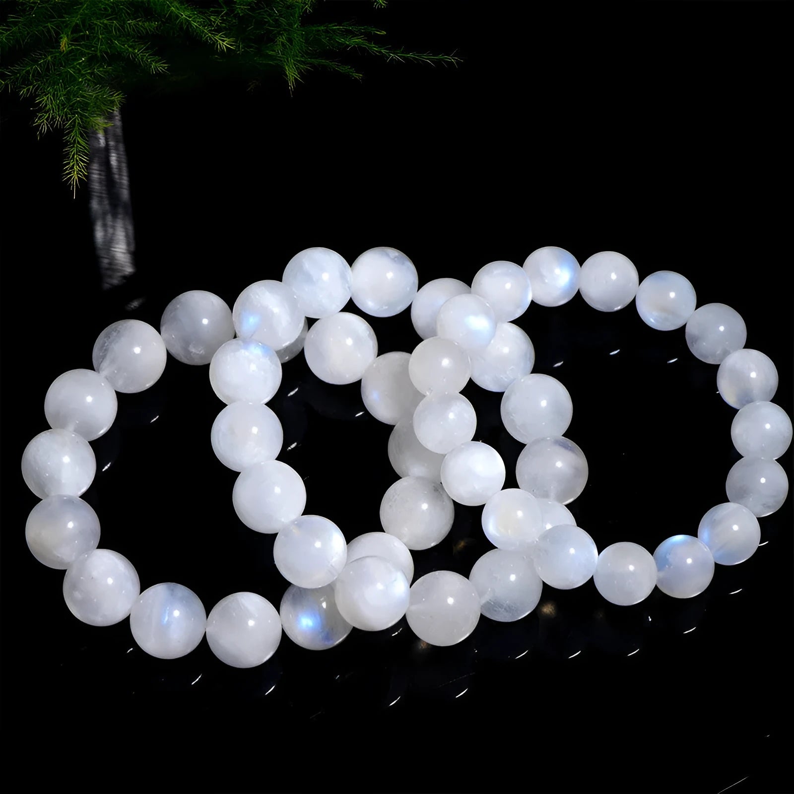 Natural blue moonlight round moonstone bead bracelet on a white background showing polished gemstone beads.