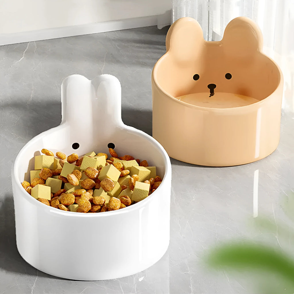 White and yellow ceramic pet feeding bowls with animal patterns in large and small sizes