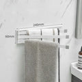 Black folding no-drill towel bar mounted on a bathroom wall with adhesive.
