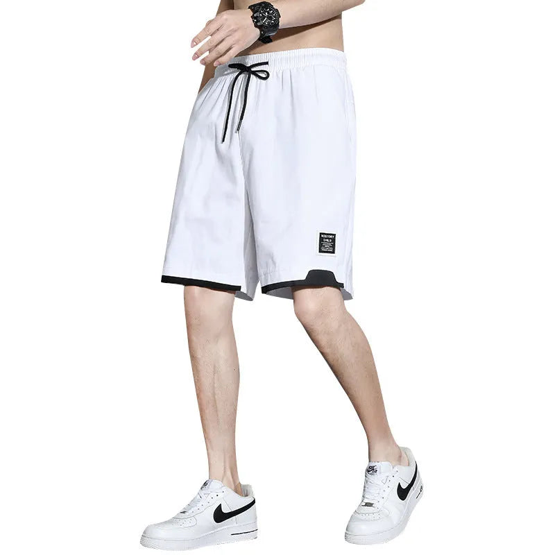 Boys' black cotton casual shorts with mid-waist, shown on a hanger.