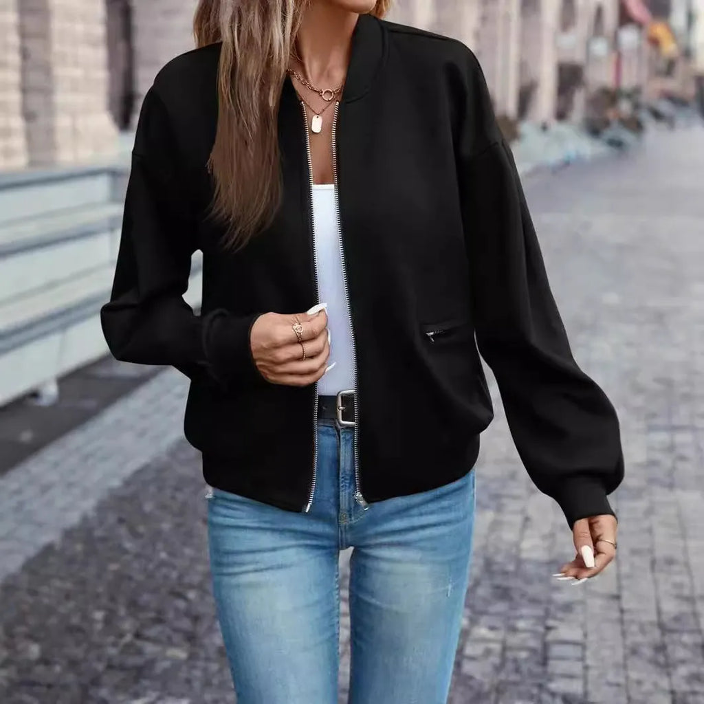 Black women's casual zip jacket with long sleeves on a hanger.