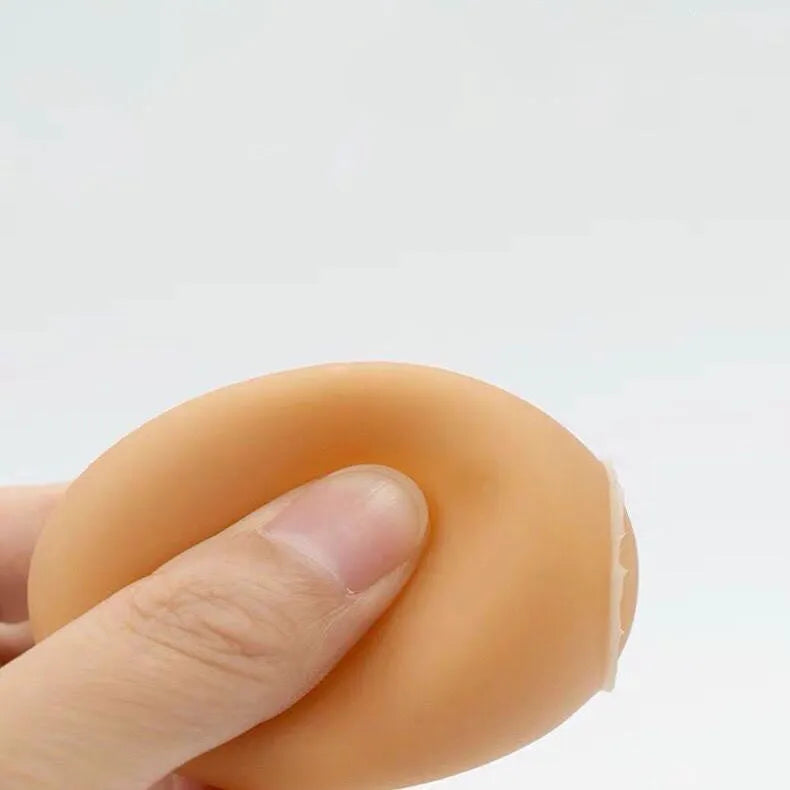Natural rubber egg-shaped dog chew toy with a squeaker inside for dental play.