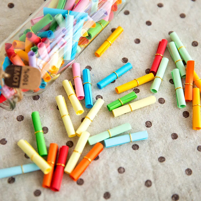 Colourful mini paper scrolls with eyelets in multiple sizes for drift bottle messages