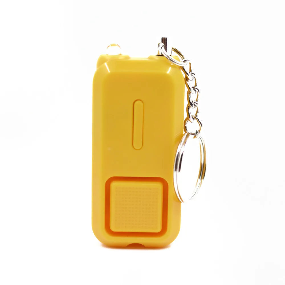 Compact pink personal safety alarm keyring with a button, shown next to its white retail box.