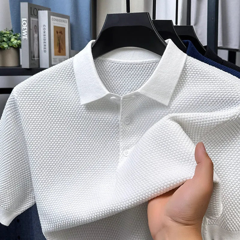 Man wearing a loose fit grey cotton short sleeve sweater, casual pullover style