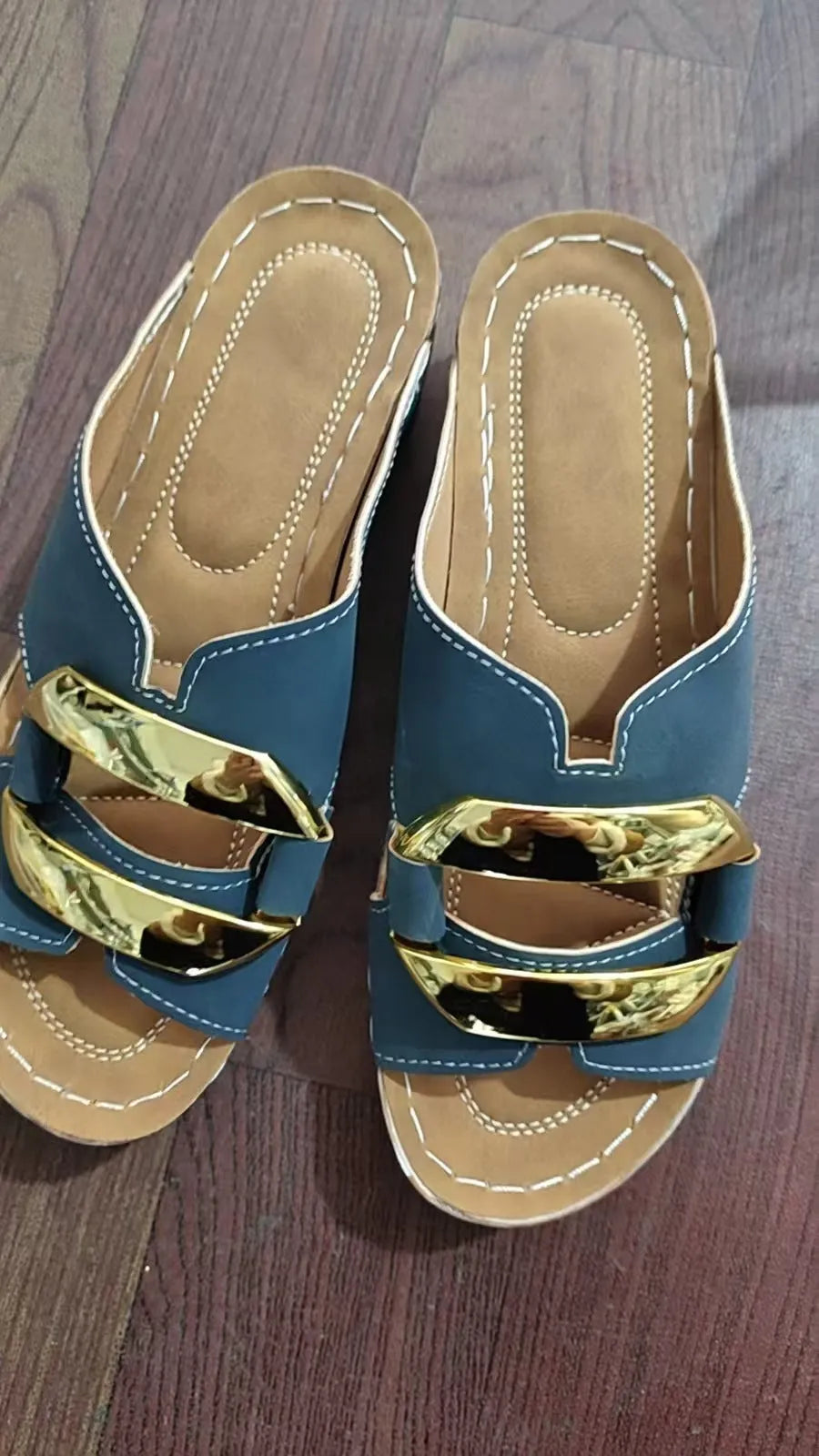 Roman style platform flip-flops in black with metal accents and rubber sole.