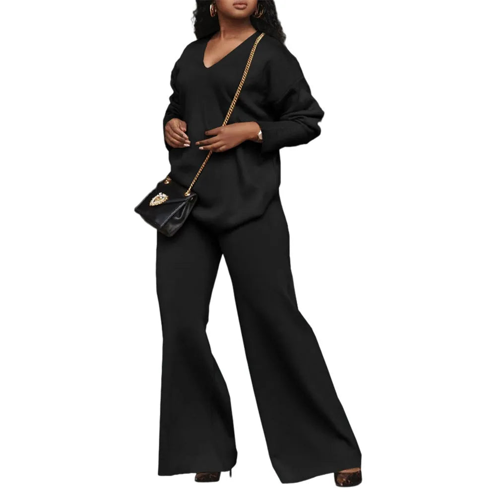 Women's brown thickened suede two-piece suit with split sleeve top and trousers on a hanger.