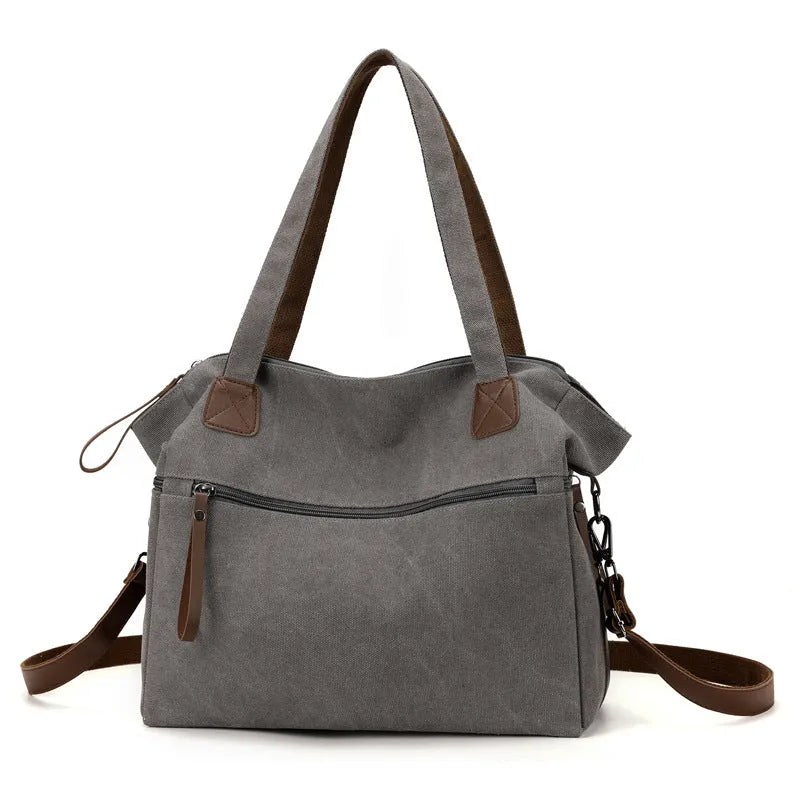 Grey retro-style canvas women's handbag with large capacity and internal pockets.