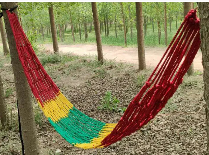 Outdoor nylon rope mesh hammock hanging between trees showing mesh construction and tying ropes