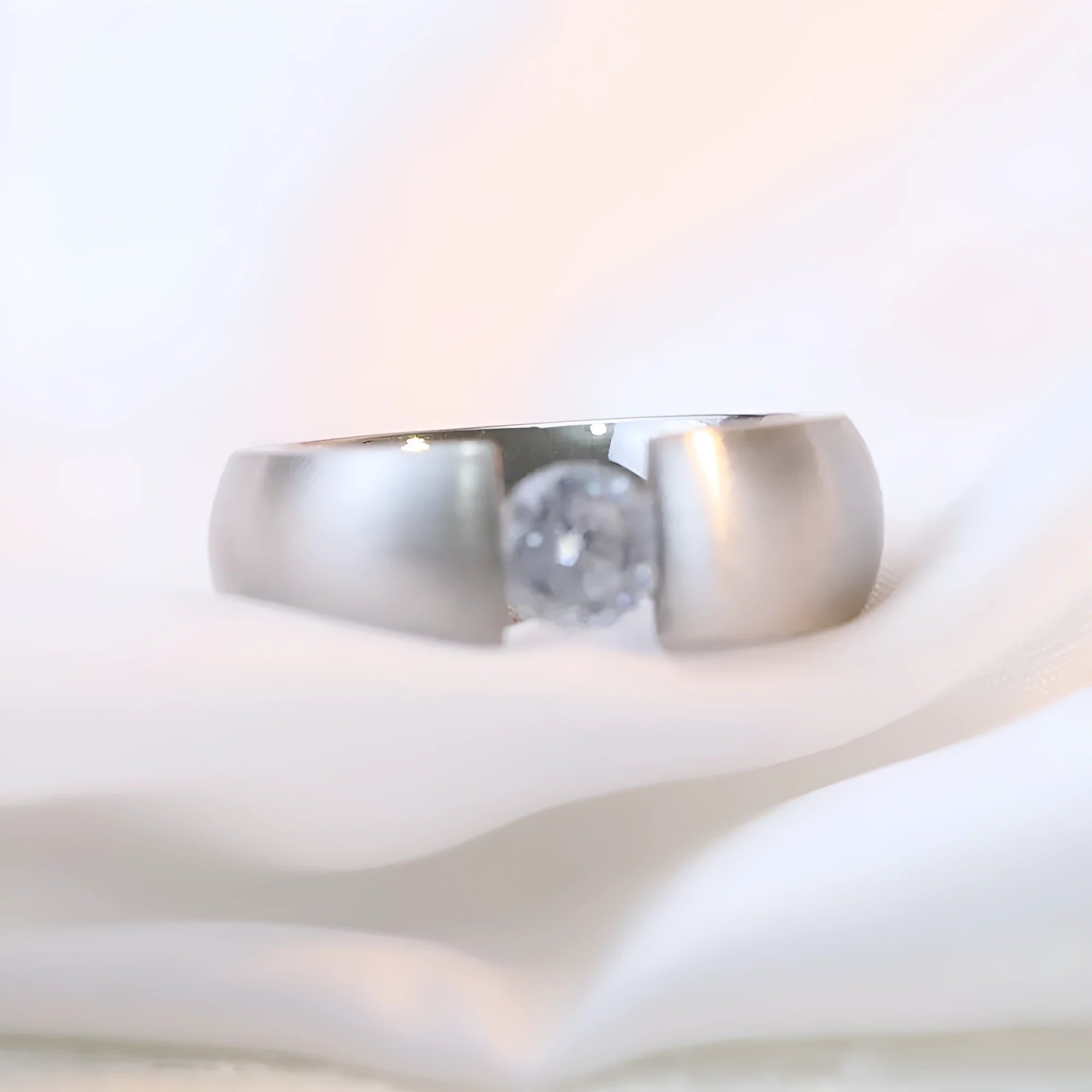 Titanium steel geometric ring with diamond treatment in gold colour finish on white background