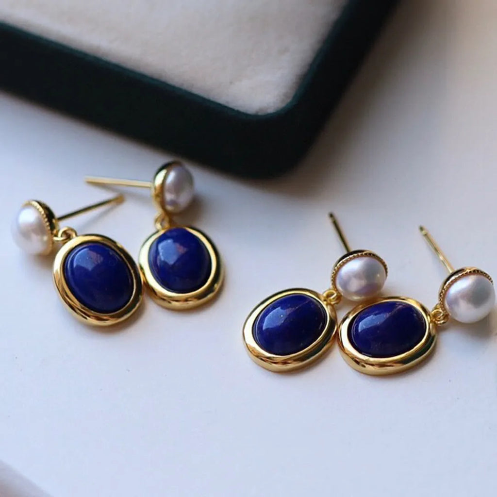A pair of simple sterling silver stud earrings with a lapis lazuli pearl colour and auspicious patterns.