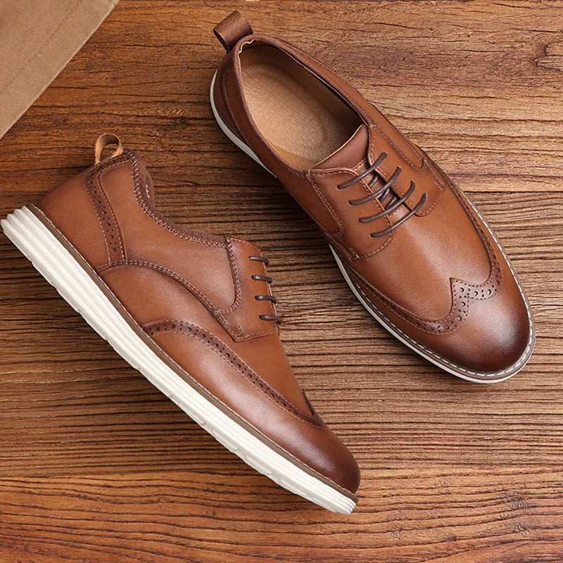 Men's black and brown slip-on business casual shoes with round toe and carved pattern detail