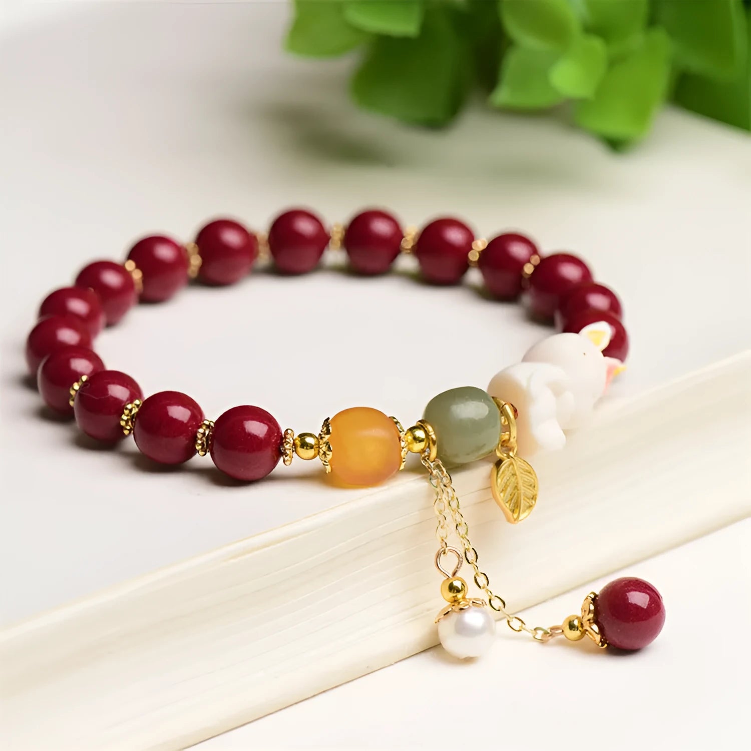 Natural cinnabar rabbit bracelet in national style design showing 8mm and 10mm size options