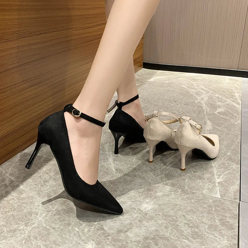 Women's black stiletto heel pumps with buckle detail and skull pattern lining