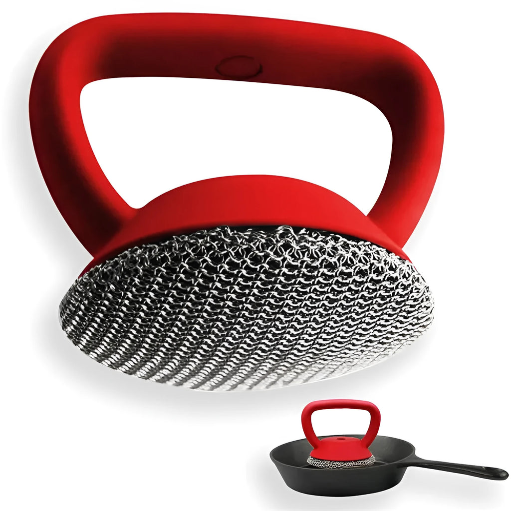 Round 316 stainless steel chainmail scrubber with red silicone handle on cast iron skillet