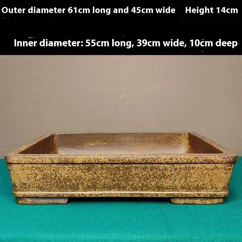 Straight shallow rectangular Yixing Zisha purple sand flowerpot on ground.