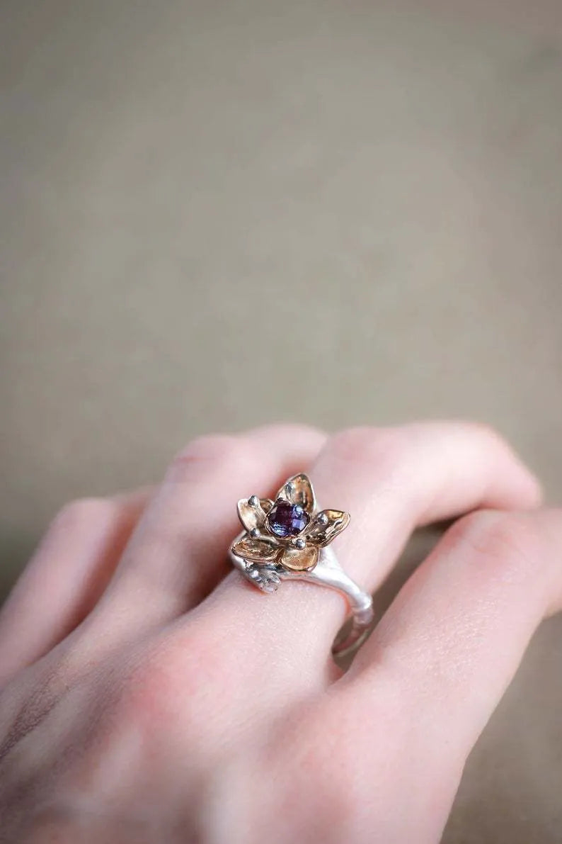 Silver two-tone floral geometric women's ring on display showing geometric shape and floral pattern detail.