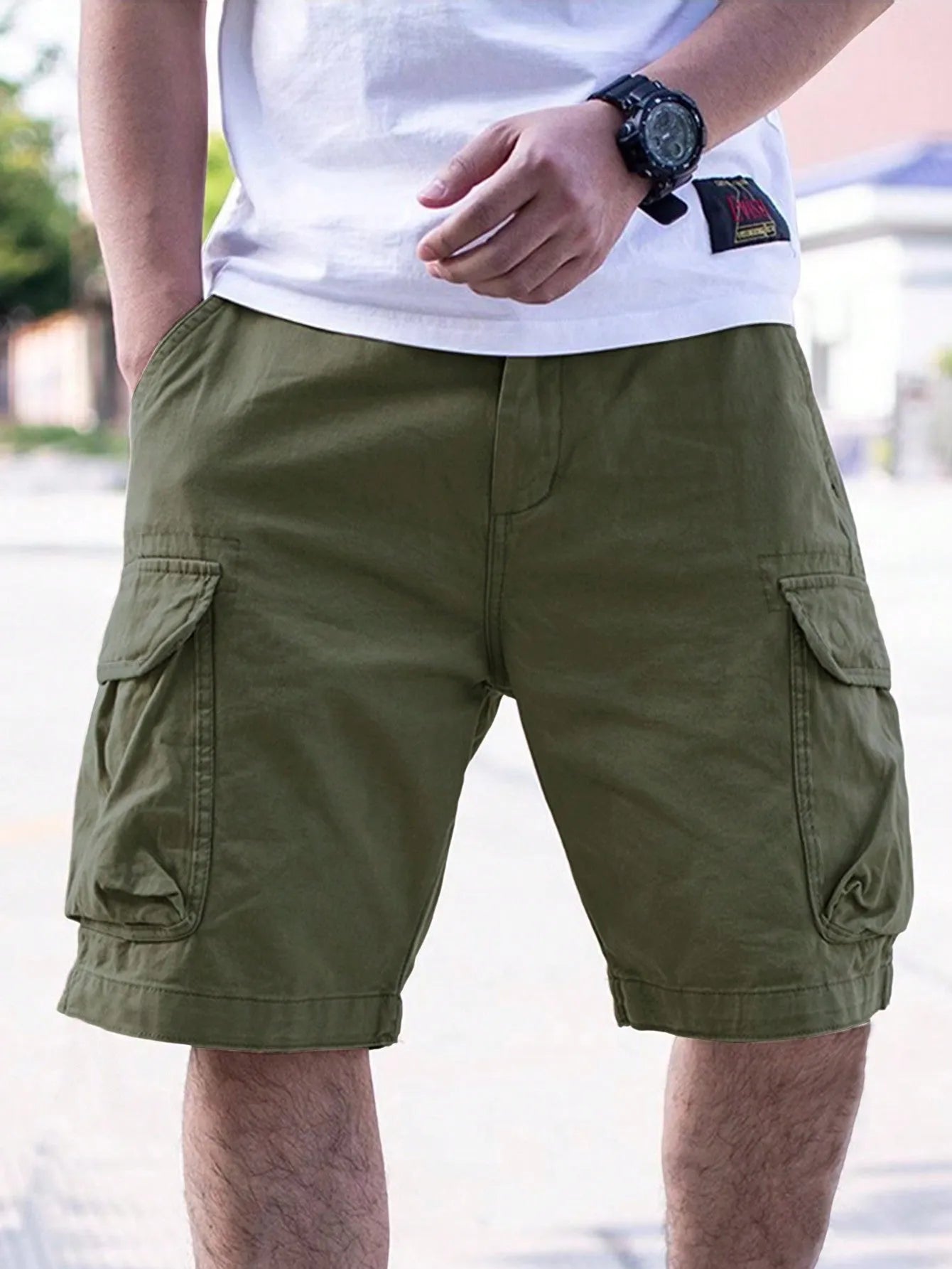 Men's loose-fit cotton blend workwear shorts in army green, shown from the front on a hanger.