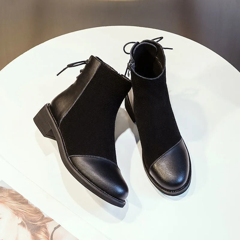 Black women's knee-high Martin boots with side zip, round toe, decorative bow, and rubber sole.