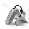 Suede car key cover shown in Cement Gray, Dark Green, Light Gray, and Orange colour options.
