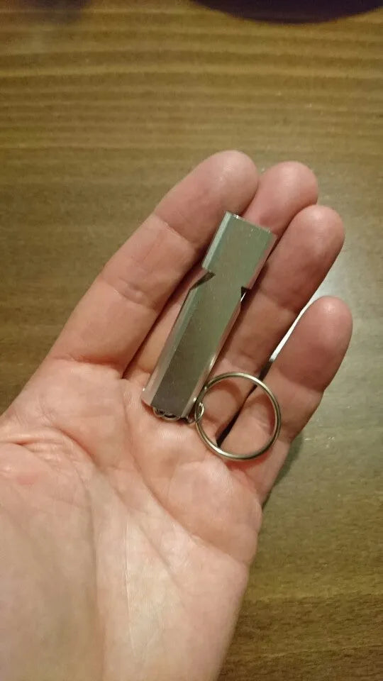 Silver and gold aluminium alloy double hole outdoor survival whistle.