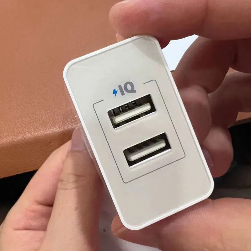 White dual-port 12W USB charger with national standard plug on a plain background