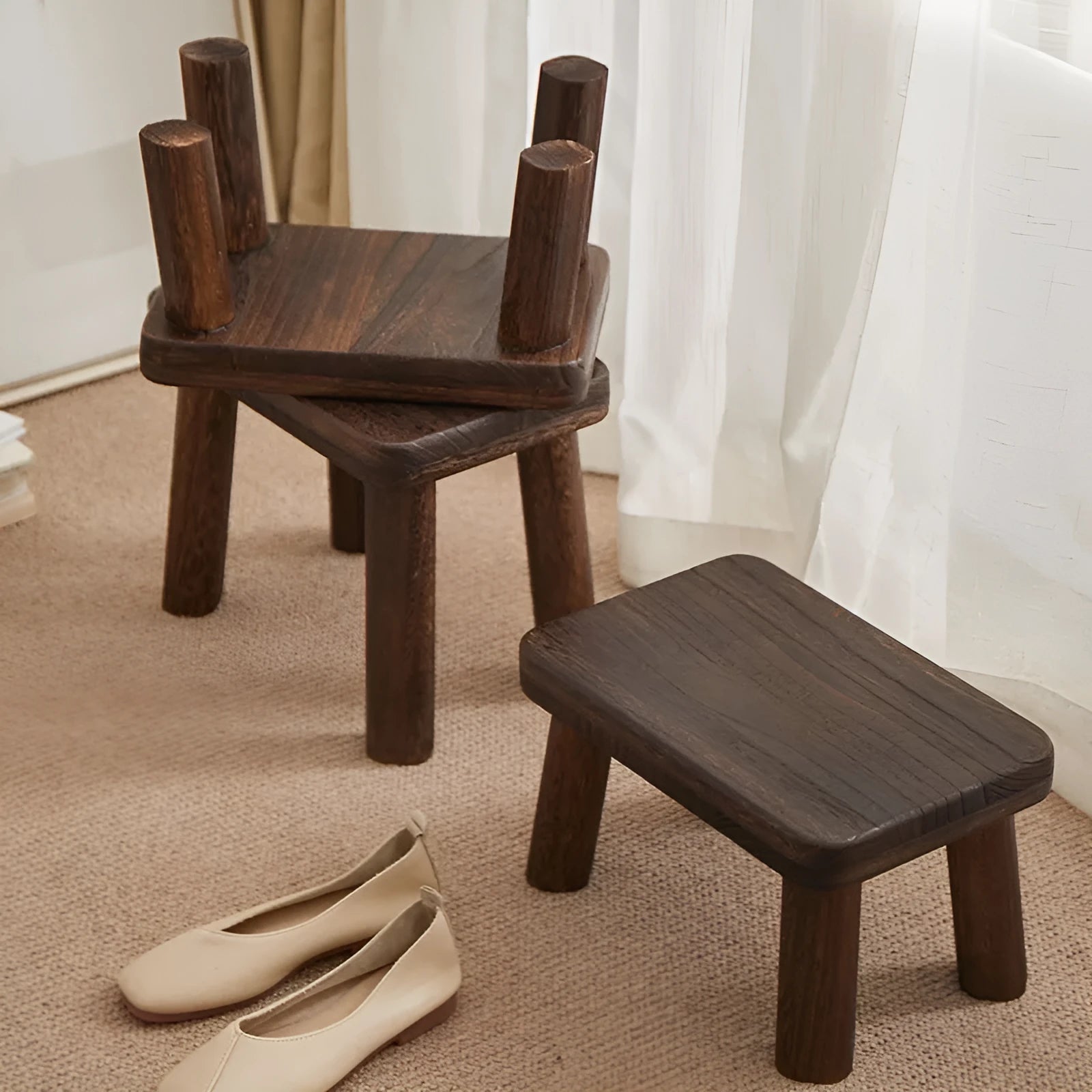 Distressed wooden shoe changing stool with bracket construction in living room setting