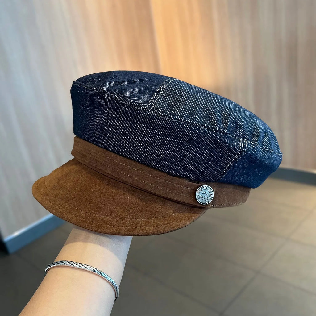 Dark blue denim adjustable octagonal newsboy cap shown on a neutral background.