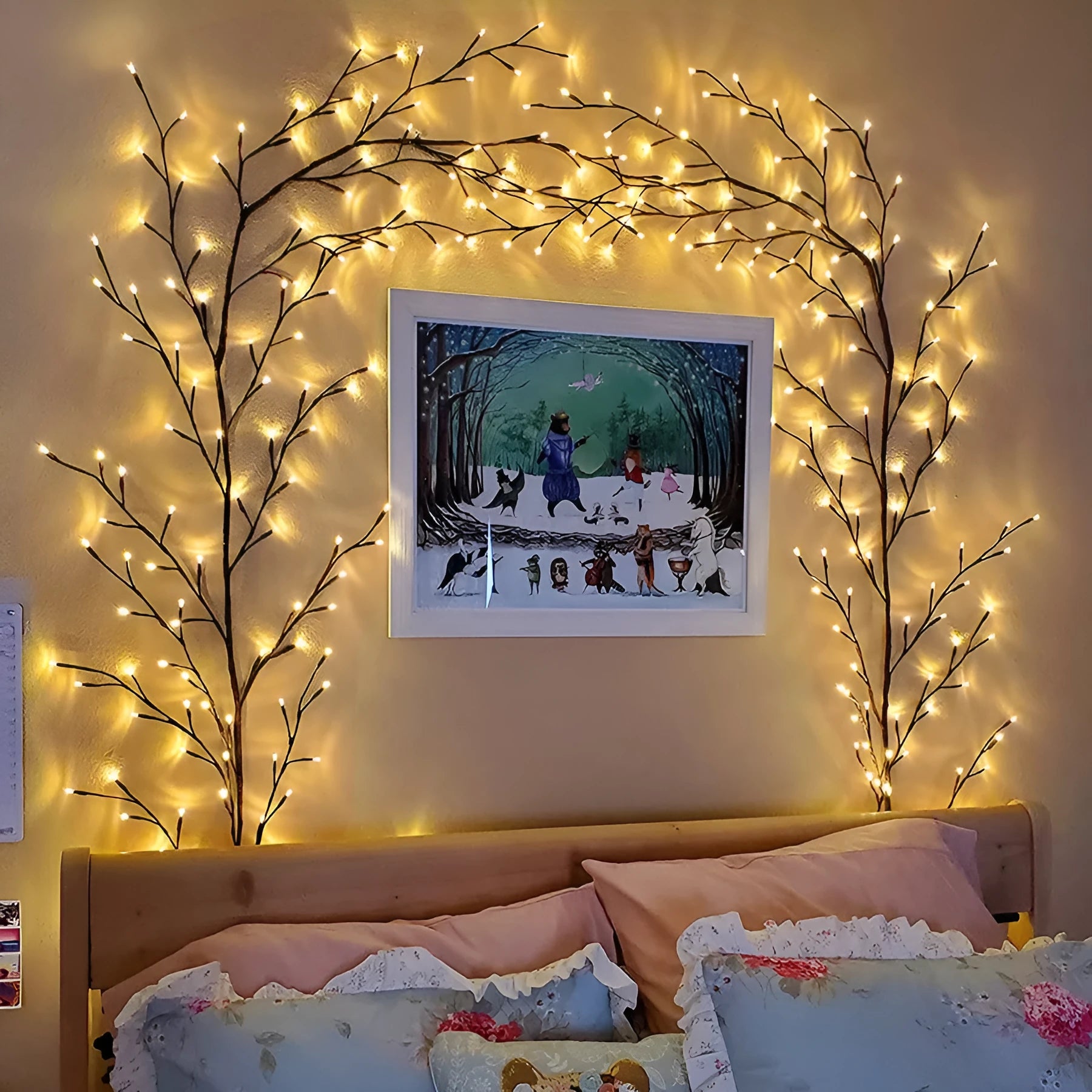 Flexible willow vine Christmas garland with warm white LED lights bent into a decorative shape on a wall.