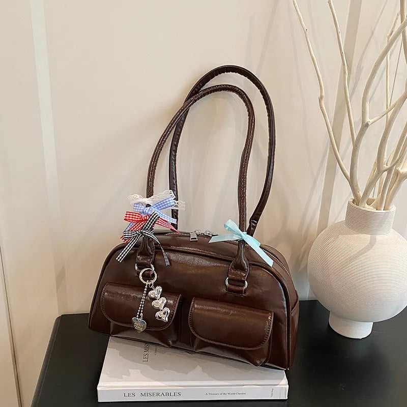 Women's black PU leather retro pillow handbag with double shoulder strap and flap closure.