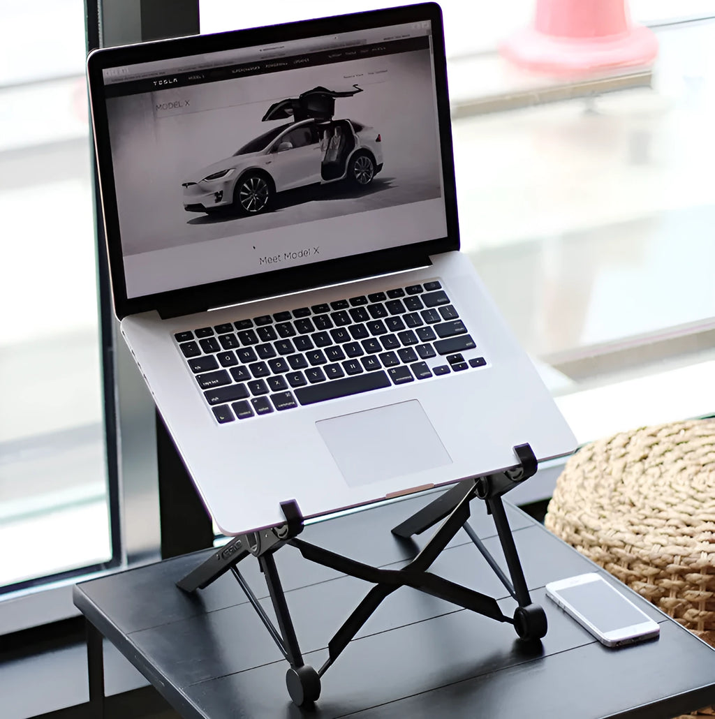 Black reinforced nylon folding laptop stand shown open in use and collapsed for storage.