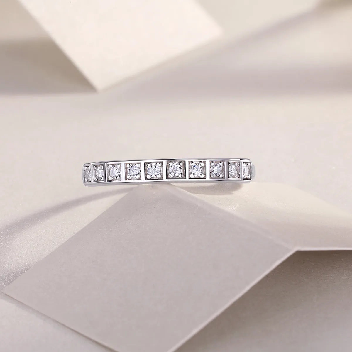 Moissanite wedding ring set on white background, S925 silver platinum plated, less than 0.1 carat stone