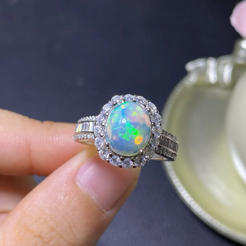 Handmade adjustable silver ring with a natural opal stone in rose gold plating.